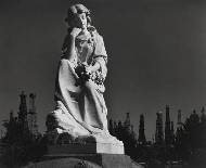 Cemetery statue and oil derricks, Long Beach, California